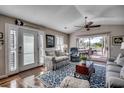 Bright living room featuring vaulted ceilings, hardwood floors and large windows with a scenic view at 9671 Stillwater Ct., Myrtle Beach, SC 29572