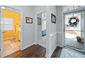 Well-lit entryway featuring wood floors and doors leading to bathroom and other rooms at 109 Astoria Park Loop, Conway, SC 29526
