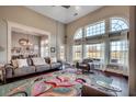 Bright living room with large windows, hardwood floors, and a colorful area rug adds comfort and elegance at 1624 Portwest Dr., Myrtle Beach, SC 29579