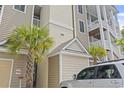 Close-up of condo's exterior showing the building number, covered entrance, and exterior finishes at 181 Ella Kinley Circle # 305, Myrtle Beach, NY 29588
