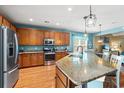 Spacious kitchen featuring an island with granite countertop, stainless steel appliances, and ample cabinet space at 1837 Orchard Dr., Myrtle Beach, SC 29577
