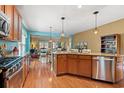 Open-concept kitchen boasts stainless steel appliances, granite countertops, and seamless flow into the dining area at 1837 Orchard Dr., Myrtle Beach, SC 29577