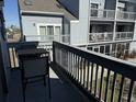 Cozy balcony with outdoor seating, perfect for relaxing and enjoying the neighborhood view at 1890 Colony Dr. # 17T, Surfside Beach, SC 29575