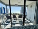 Cozy balcony with four chairs providing beautiful views of the beach and ocean at 2000 S Ocean Blvd. # V401 A&B, Myrtle Beach, SC 29577