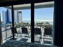 Oceanfront balcony with four chairs offering stunning views of the beach and ocean at 2000 S Ocean Blvd. # V401 A&B, Myrtle Beach, SC 29577
