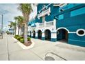 Beautiful resort exterior featuring blue accents, tropical landscaping and well-maintained walkways at 2201 S Ocean Blvd. # 2010-2011, Myrtle Beach, SC 29577