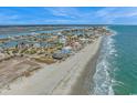 Expansive aerial shot of a coastal community with stunning waterfront homes and beach access at 2201 S Waccamaw Dr., Murrells Inlet, SC 29576