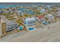 Stunning aerial view of a luxurious beach home with a pool, neighboring waterfront houses and ocean access at 2201 S Waccamaw Dr., Murrells Inlet, SC 29576