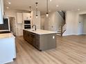 New kitchen boasts a large island, stainless appliances, white cabinets, and an open floor plan at 2317 Hazel Way, Longs, SC 29568