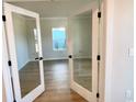 Inviting living room with pristine hardwood floors seen through glass doors at 2317 Hazel Way, Longs, SC 29568