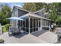 Spacious screened-in porch and wooden deck with outdoor dining, perfect for entertaining at 316 13Th Ave. N, Surfside Beach, SC 29575