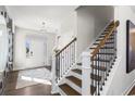 Grand foyer with wood flooring, white door, and stairs at 4043 Bucolic Loop, Myrtle Beach, SC 29588