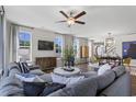 Bright living room with a ceiling fan, large windows, and comfortable sectional couch at 4043 Bucolic Loop, Myrtle Beach, SC 29588