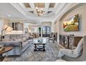 Beautiful living room with coffered ceilings, chandelier, hardwood floors, and sophisticated decor at 410 44Th Ave. N, Myrtle Beach, SC 29577