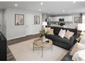 Open-concept living room with modern decor, comfortable seating, and seamless flow to the kitchen at 430 Myrtle Meadows Dr, Conway, SC 29526