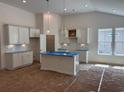 Bright, spacious kitchen featuring white cabinetry, an island and abundant natural light at 444 Sun Colony Blvd., Longs, SC 29568
