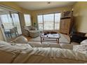 Cozy living room boasts comfortable seating, natural light, and sliding door access to the outside at 4633 Lightkeepers Way # 5K, Little River, SC 29566