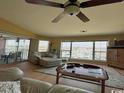 Inviting living room featuring a ceiling fan, comfortable seating, and a marina view at 4633 Lightkeepers Way # 5K, Little River, SC 29566