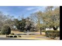 Scenic view of a pond with a fountain surrounded by lush trees and manicured landscaping at 4633 Lightkeepers Way # 5K, Little River, SC 29566