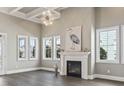 Bright living room featuring a fireplace, large windows, wood floors and stylish decor at 5220 Mount Pleasant Dr., Myrtle Beach, SC 29579