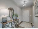 Welcoming foyer with a decorative table, mirror, and stylish lighting at 5419 Shelly Lynn Dr., Myrtle Beach, SC 29579