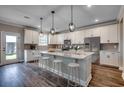 Modern kitchen featuring stainless steel appliances, an island with barstool seating, and hardwood floors at 5430 Shelly Lynn Dr., Myrtle Beach, SC 29579