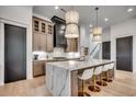 Kitchen featuring an island with a waterfall edge and modern pendant lighting at 5515 Porcher Ave., Myrtle Beach, SC 29577