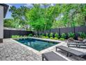 Backyard pool with brick surround and black lounge chairs at 5515 Porcher Ave., Myrtle Beach, SC 29577