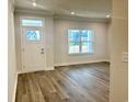 Bright living room with luxury vinyl plank flooring, white trim, and a large window at 9021 Aria Way, Longs, SC 29568