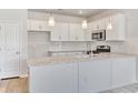 New kitchen with white cabinets, granite countertops, stainless steel appliances, and subway tile backsplash at 915 Agostino Dr., Myrtle Beach, SC 29579