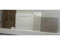 Selection of interior design samples showcasing flooring, cabinet door, backsplash and countertop materials at 915 Agostino Dr., Myrtle Beach, SC 29579