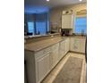 Well-appointed kitchen with granite countertops, white cabinetry, modern appliances, and tiled floor at 1001 Ray Costin Way # 1605, Murrells Inlet, SC 29576