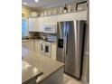 Bright kitchen with white cabinets, modern stainless steel appliances, and ample counter space for meal preparation at 1001 Ray Costin Way # 1605, Murrells Inlet, SC 29576