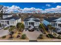 Expansive aerial view of elevated home, showcasing its waterfront location and proximity to nearby city amenities at 1004 Marsh View Dr., North Myrtle Beach, SC 29582