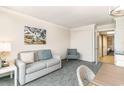 Comfortable living room with a sofa, a chair, and access to another room with tile floors at 1105 S Ocean Blvd. # 220, Myrtle Beach, SC 29577