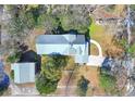 Aerial view of home with metal roof, detached garage, and driveway at 112 S Rosemary Ave., Andrews, SC 29510
