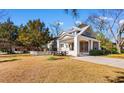 Two-story home with a carport and screened porch in a grassy yard at 112 S Rosemary Ave., Andrews, SC 29510
