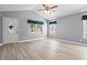 Bright living room with vaulted ceilings, wood-look floors, and large windows at 125 Dayglow Dr., Loris, SC 29569