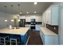 Modern kitchen with an island, stainless steel appliances, and white cabinets at 1330 Reflection Pond Dr., Little River, SC 29566
