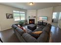 Cozy living room features a fireplace, large windows, and a comfortable sectional sofa at 1330 Reflection Pond Dr., Little River, SC 29566