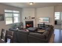 Spacious living area with dark hardwood floors, a fireplace, and abundant natural light at 1330 Reflection Pond Dr., Little River, SC 29566