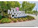 The Market Common signage surrounded by manicured landscaping and mature trees creating a beautiful entryway at 1575 Berkshire Ave., Myrtle Beach, SC 29577