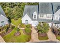 An overhead view of a charming townhome with a well-manicured lawn, landscaping, and driveway at 182 Wimbledon Way # 182, Murrells Inlet, SC 29576