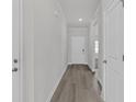 Interior hallway view featuring hard surface floors, trim, and neutral paint at 2020 Copper Creek Loop, Longs, SC 29568