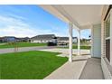 A view from the covered porch shows a well-kept lawn and the surrounding homes in the neighborhood at 2052 Copper Creek Ct., Longs, SC 29568
