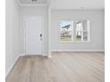 Well lit Living room featuring light wood flooring, fresh white walls, and large windows at 2104 Copper Creek Ct., Longs, SC 29568