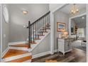 Elegant foyer with hardwood stairs, stylish decor, and a glimpse into the adjacent living space at 2325 Highway 111, Little River, SC 29566