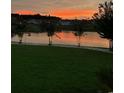Sunset over a beautiful pond with lush green grass in the backyard at 2526 Great Scott Dr., Myrtle Beach, SC 29579