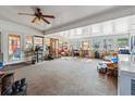 Spacious sunroom featuring multiple windows, a ceiling fan, and carpet flooring at 2945 Old Railroad Rd., Conway, SC 29527