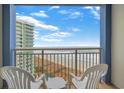 Balcony view from this condo shows the ocean and beach from above with comfortable seating at 300 N Ocean Blvd. # 1026, North Myrtle Beach, SC 29582